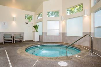 a hot tub in a room with windows